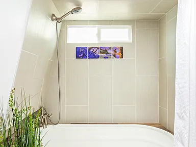 1957 trailer horse trough bath tub white with grey tile and local artwork