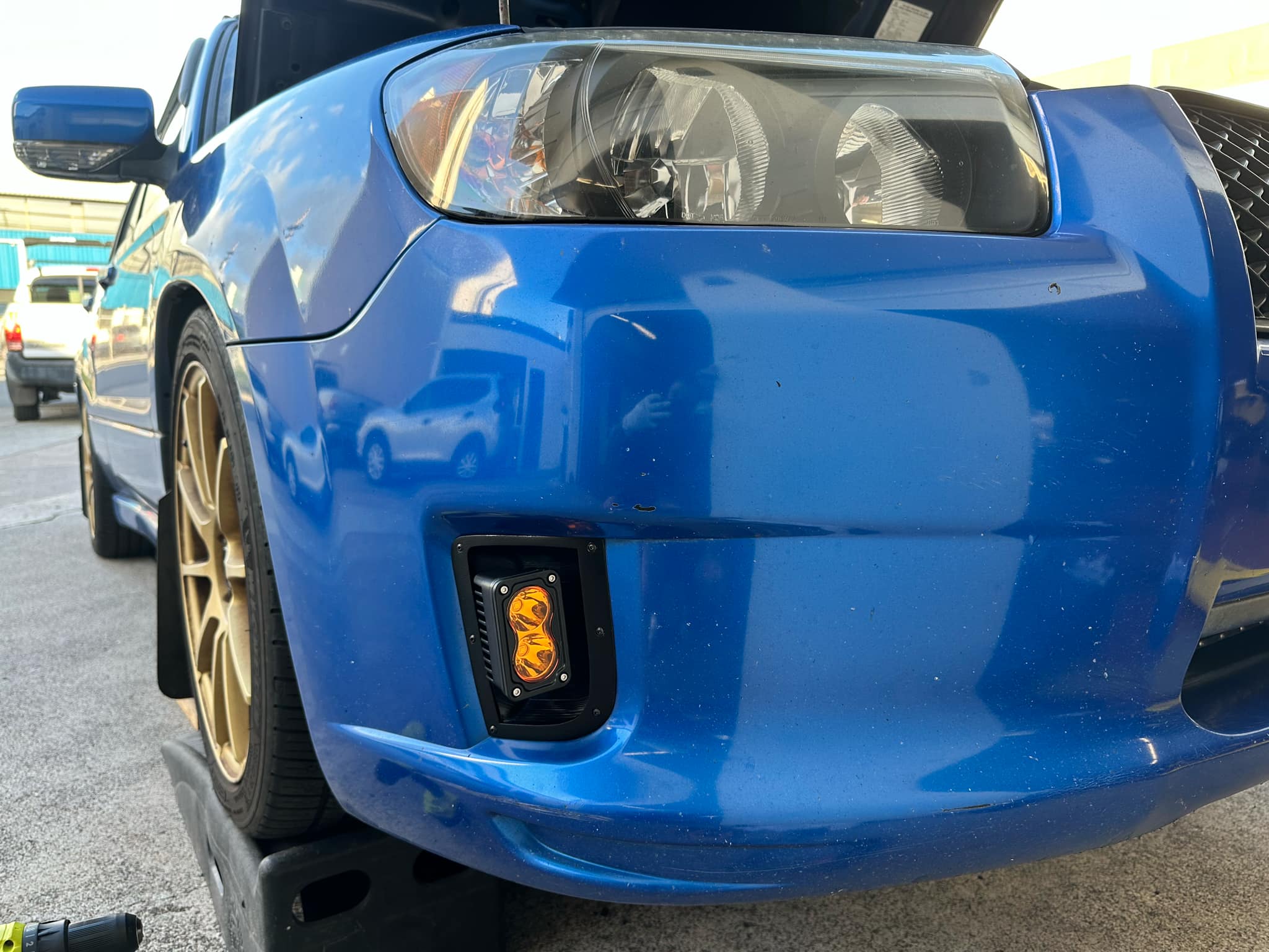 Close-up of the amber fog light seated in the Sports bumper housing