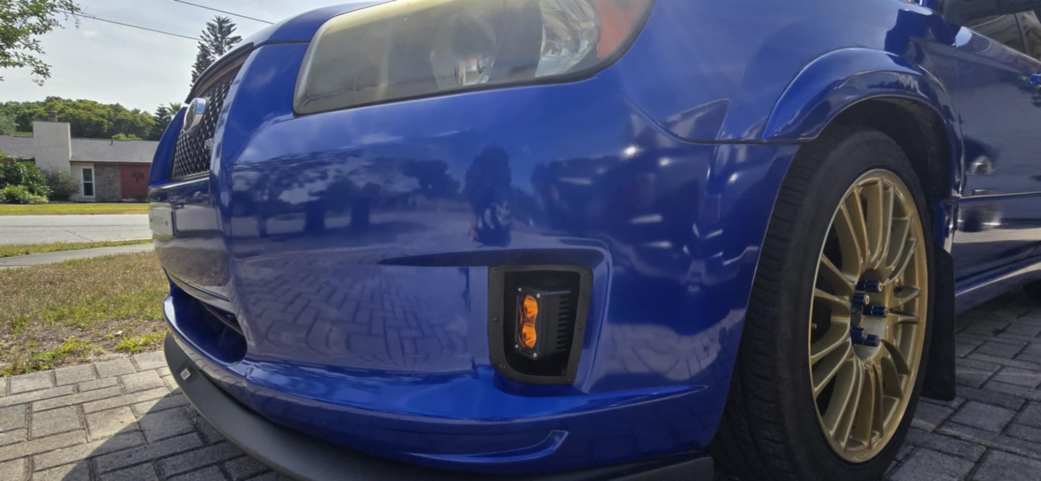 Low angle close-up of the amber fog light in the Sports bumper